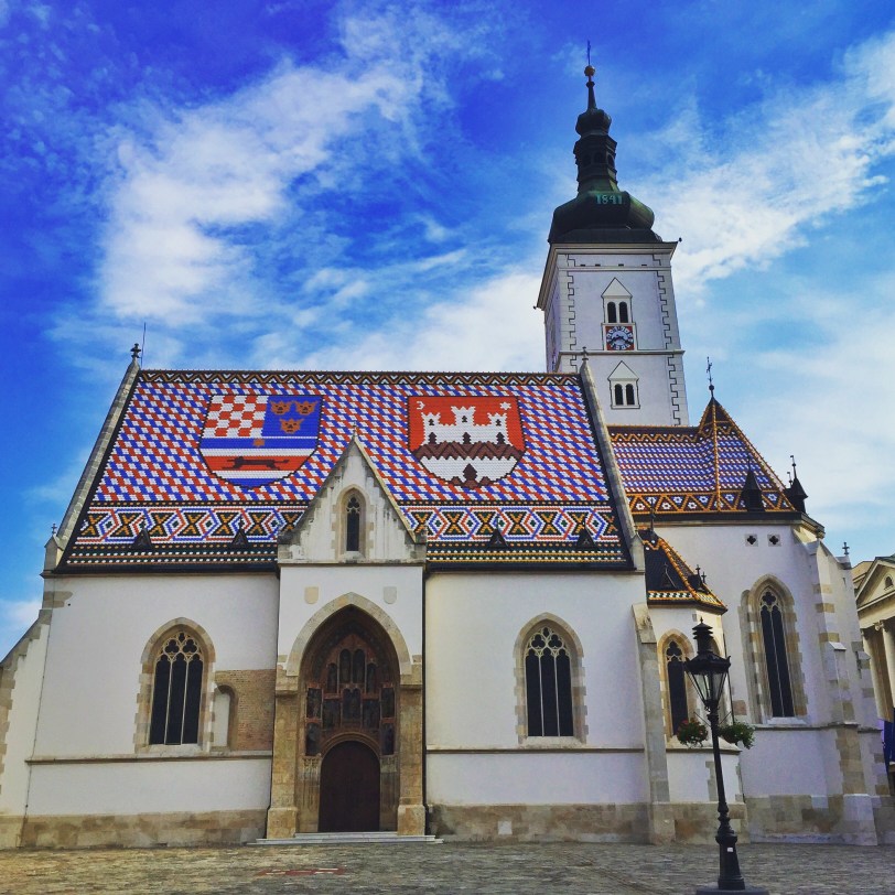 Down the street is St. Mark's church with the Croatian flag on the roof.