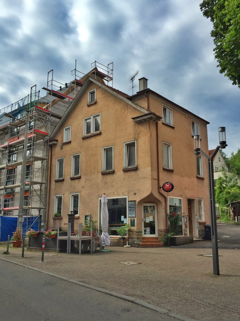 Turning back on our road is this cafe (with an apartment building being built next store). This is a good place to stop for a glass of wine on the way home.